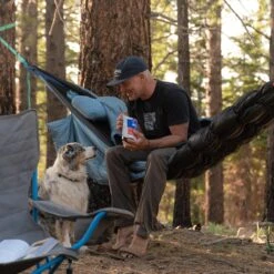 Grand Trunk Siesta Hammock Pillow -Outdoor Research Store Grand Trunk Siesta Hammock Lifestyle Man and Dog